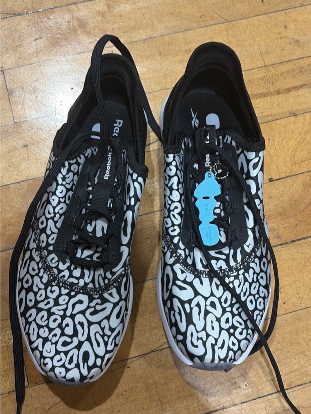Reebok Women’s Black & White Leopard Print Slip-On Sneakers